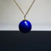14mm imperial lapis lazuli pendant centered on a fine gold-tone chain