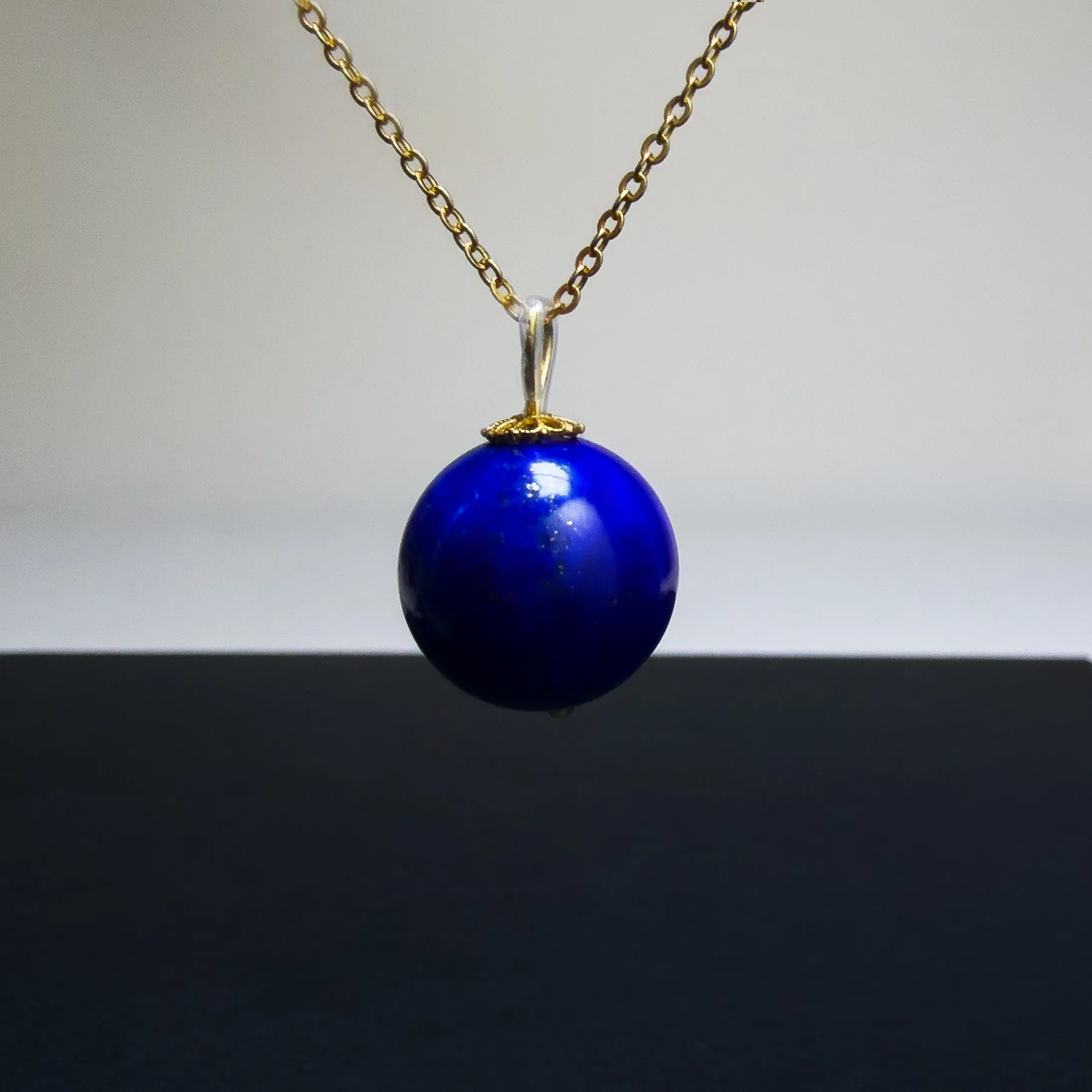 14mm imperial lapis lazuli pendant centered on a fine gold-tone chain