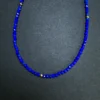 Fine 2 mm faceted blue lapis beads with evenly spaced gold accents