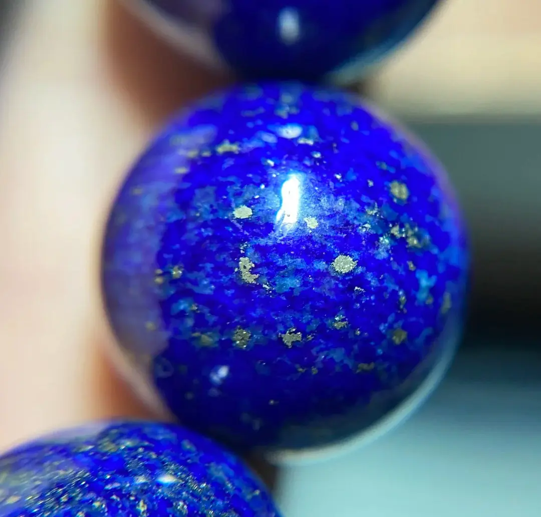 The gold-colored metallic flecks in natural lapis lazuli are typically pyrite.