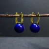 Natural Afghan lapis lazuli leverback earrings hanging from a twig