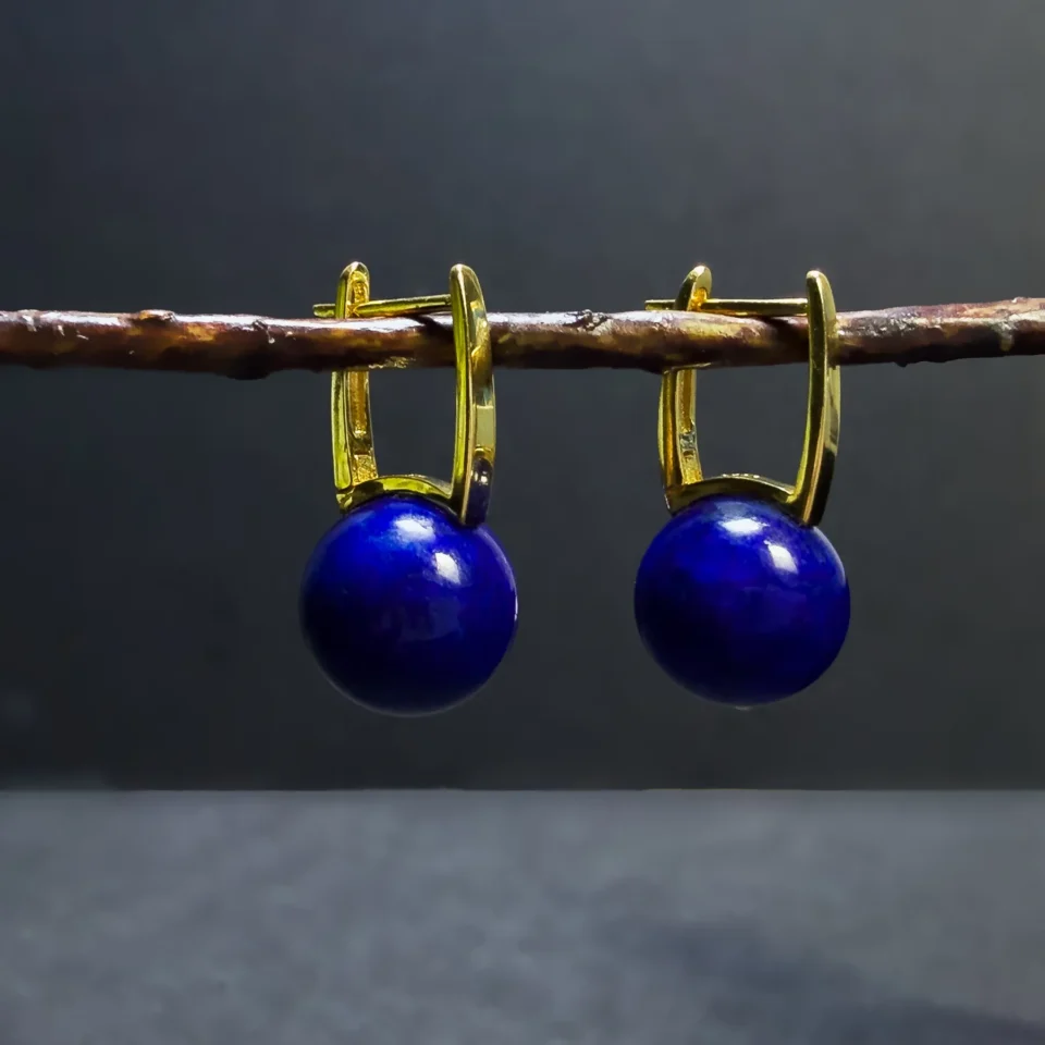 Natural Afghan lapis lazuli leverback earrings hanging from a twig