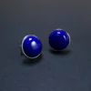 Three-quarter view of high-dome lapis cabochon earrings in S925 silver bezels