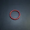 Full overhead view of the blue and orange-red elastic gemstone bracelet