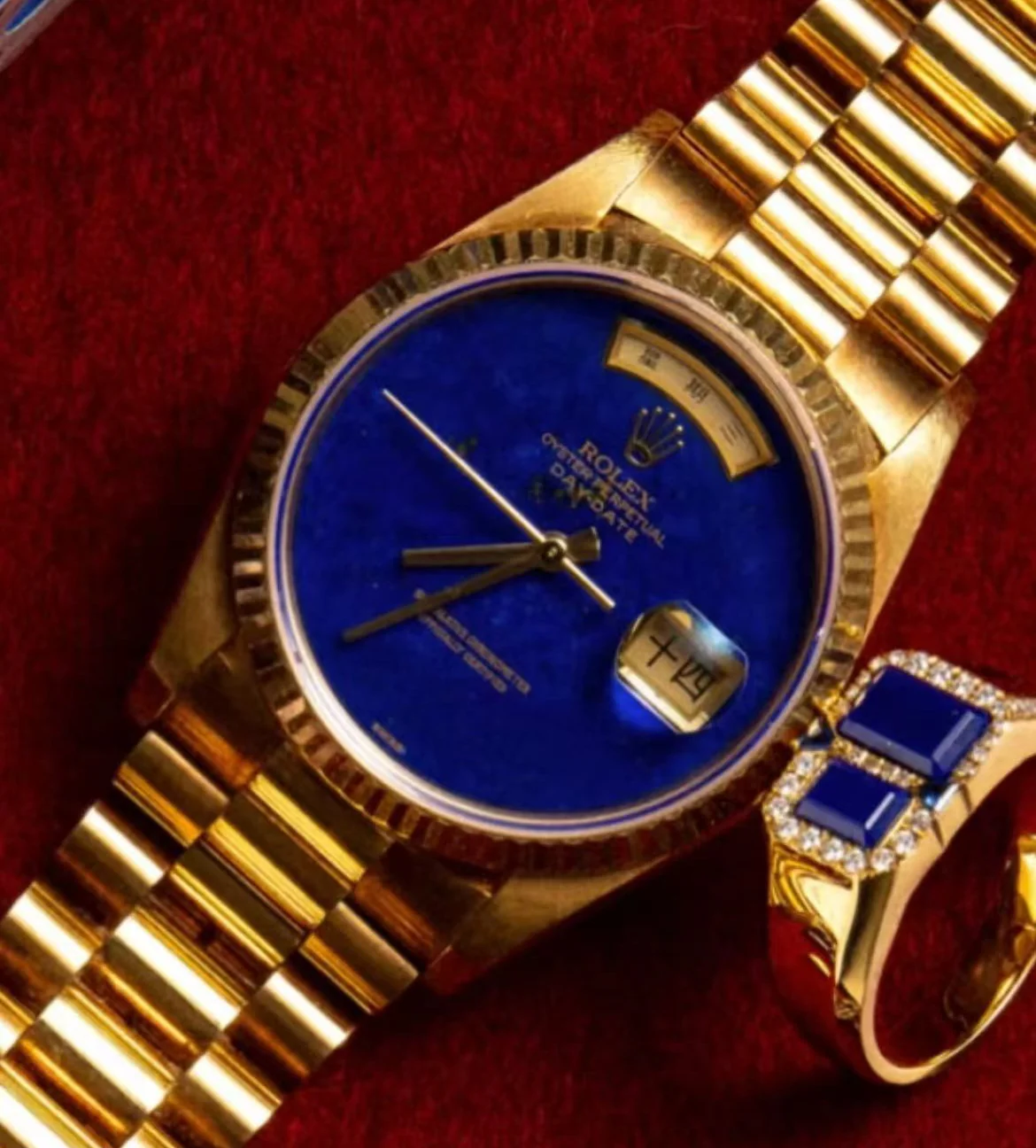 Dark blue stone ring styled beside a luxury watch