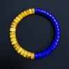 Overhead detail of blue lapis and yellow amber flat disc beads