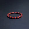 Low-angle view of color-block lapis lazuli and red agate bracelet