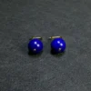 Close view of deep-blue round lapis beads with gold-tone leverbacks