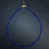 Complete delicate lapis lazuli micro bead necklace on a dark background