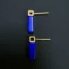Two geometric lapis earrings viewed from behind with straight gold posts