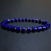 Low-angle full bracelet view with geometric blue lapis beads and gold-tone spacers