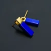Overlapping blue lapis earrings showing matte gold square settings and posts