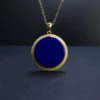 Round lapis lazuli pendant with finely textured gold-plated border