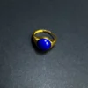 Front view of blue lapis lazuli cabochon in a gold-tone adjustable ring