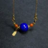 Close view of gold-plated silver fittings around blue lapis pendant