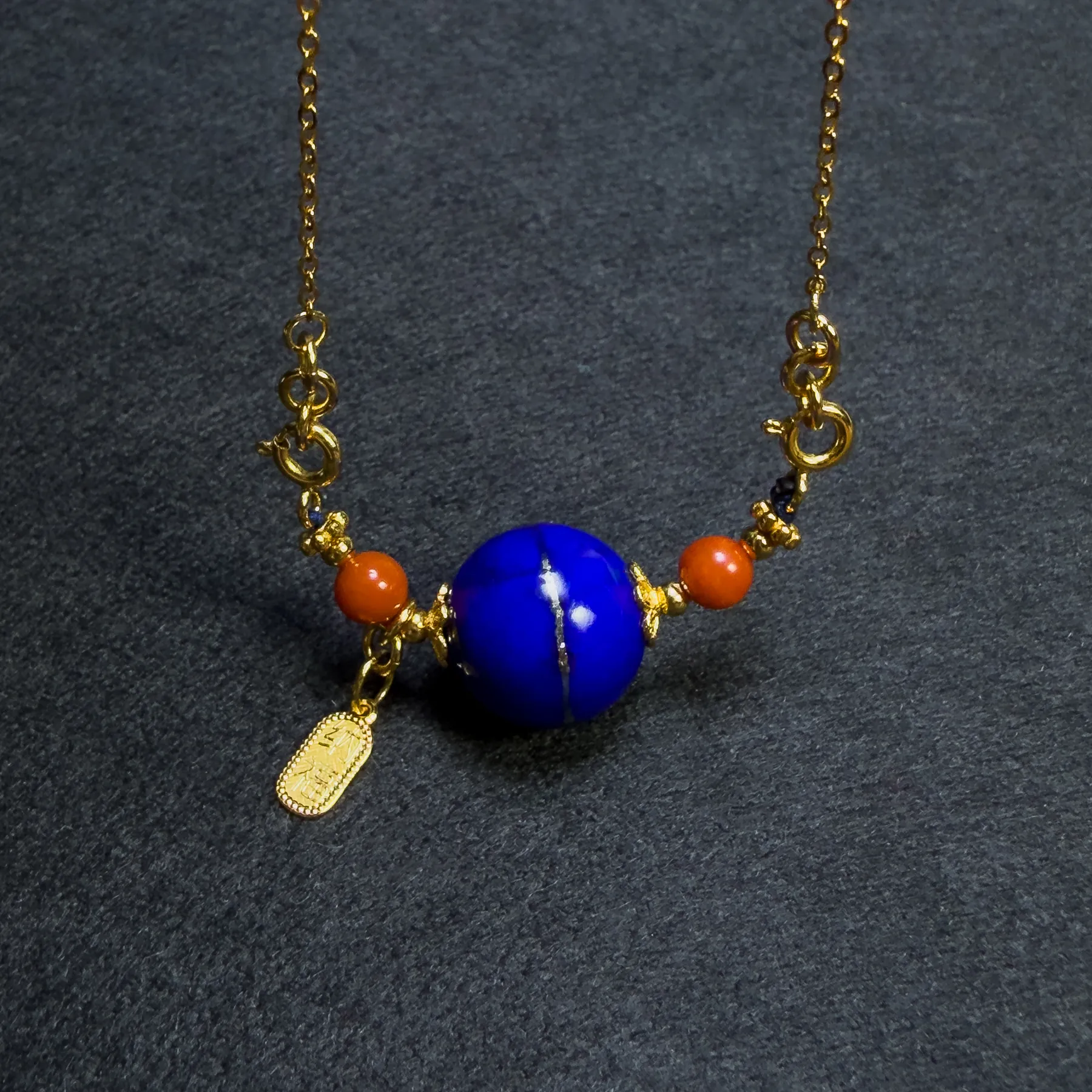 Close view of gold-plated silver fittings around blue lapis pendant