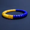 Angled bracelet view with honey amber and lapis beads meeting in front