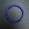Overhead view of a royal-blue lapis bracelet with alternating gold-plated sterling silver beads