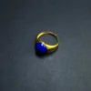 Three-quarter view of an imperial-blue lapis lazuli adjustable ring
