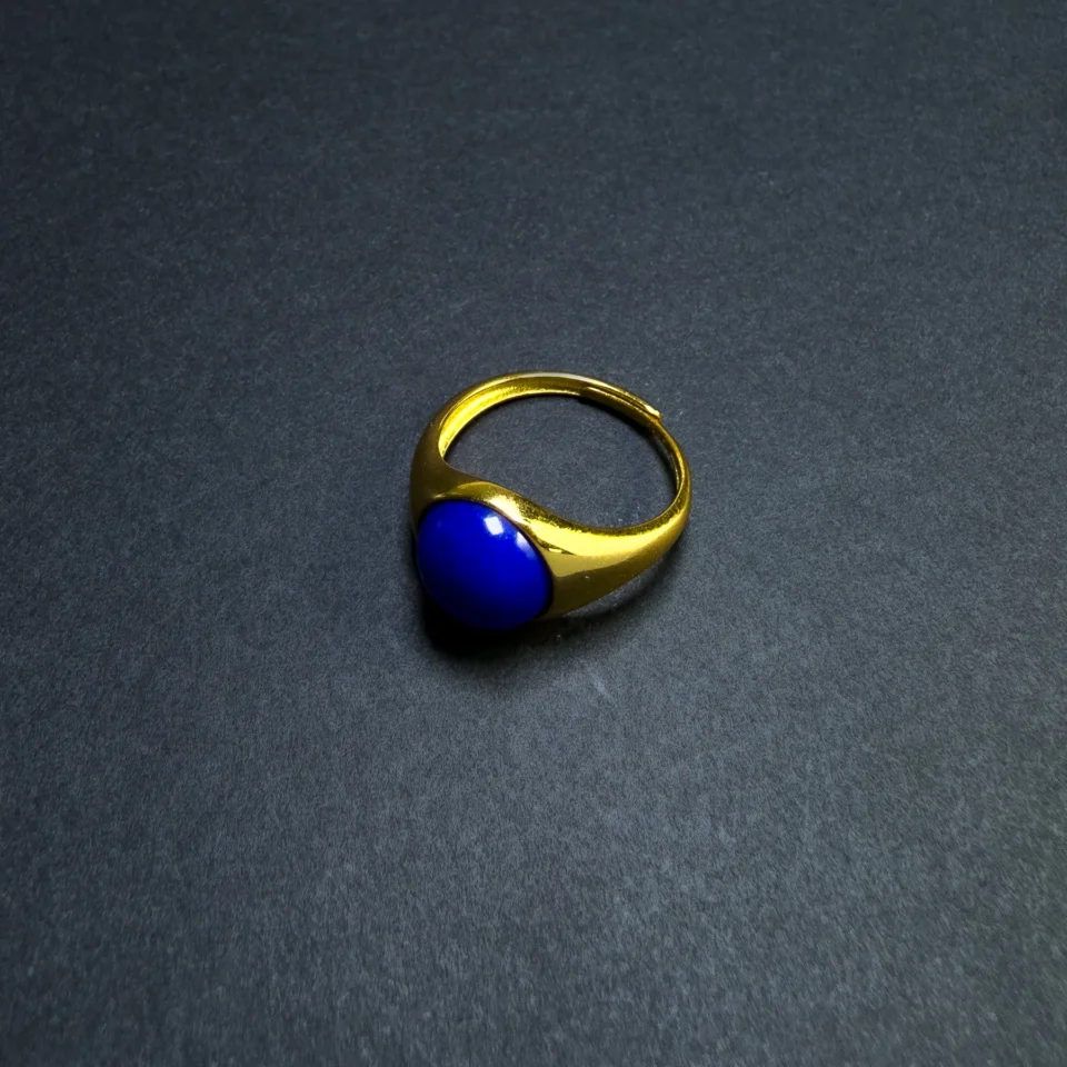 Three-quarter view of an imperial-blue lapis lazuli adjustable ring