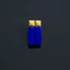 Paired blue rectangular lapis earrings aligned upright on a dark background