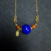 Front detail of imperial-blue lapis pendant with golden mineral ring