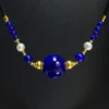 Imperial lapis and freshwater pearl cord necklace close-up on black