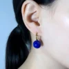 Model wearing photo of natural lapis lazuli bead drop earrings