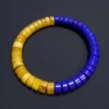 Blue lapis lazuli and yellow amber heishi bracelet in a circular layout