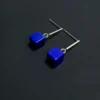 Pair of blue lapis lazuli cube earrings with polished silver bar studs