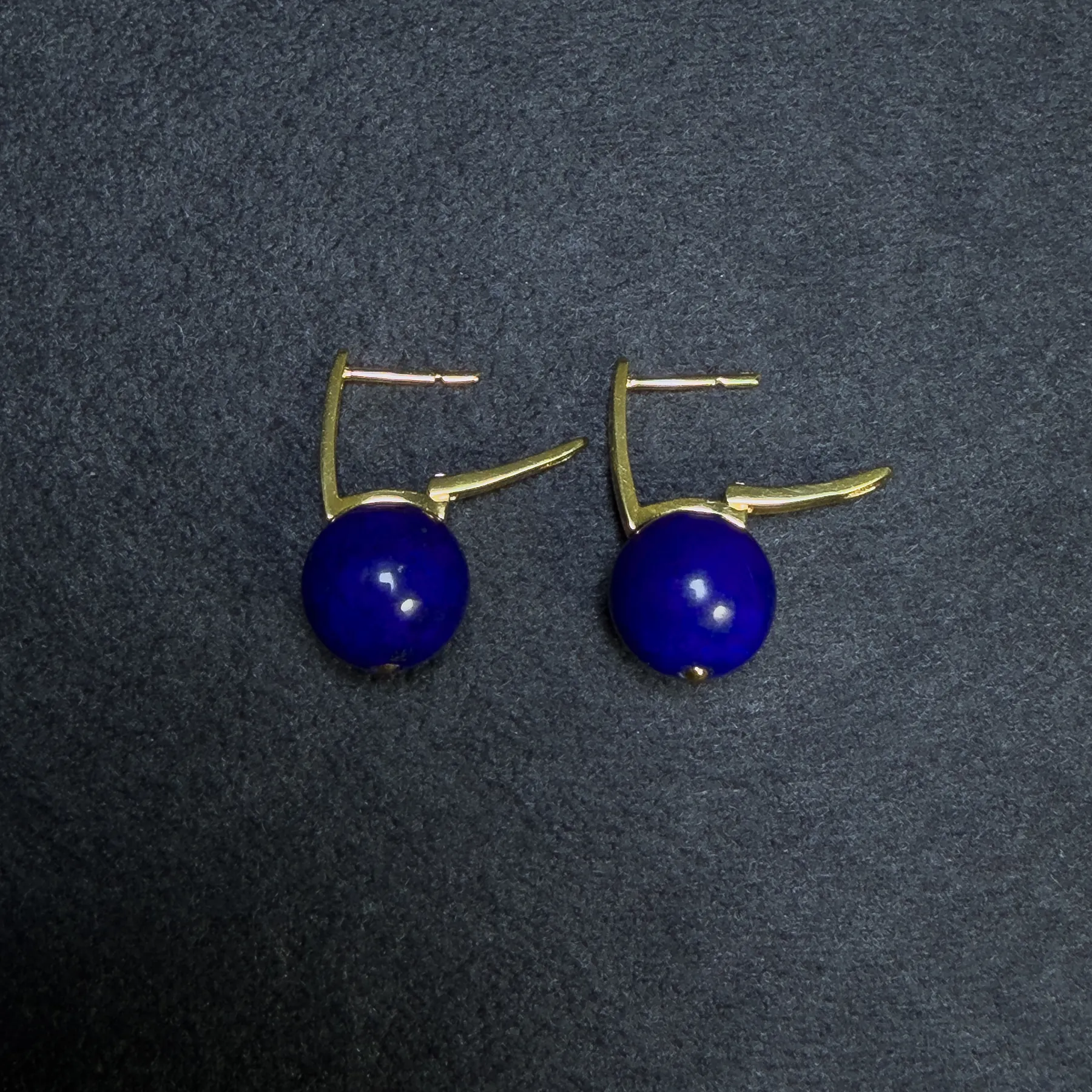 Open leverback clasp detail on gold-tone lapis lazuli earrings