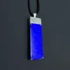 Angled view of lapis lazuli pendant with silver Greek Key detail