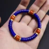Lapis lazuli and Nanhong bracelet held across an open hand for scale