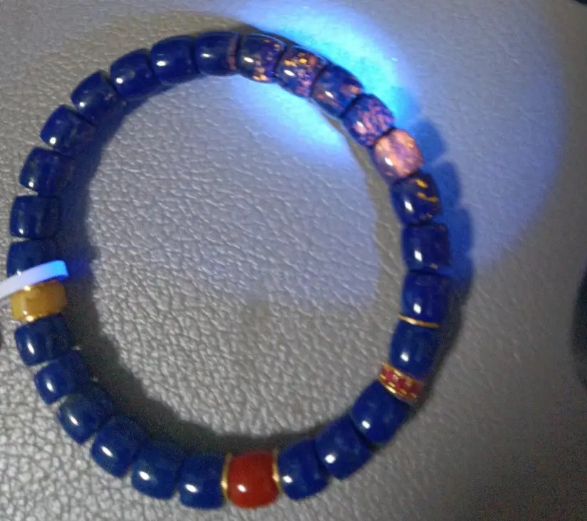 Lapis lazuli bead bracelet with varied blue stones and contrasting accent beads