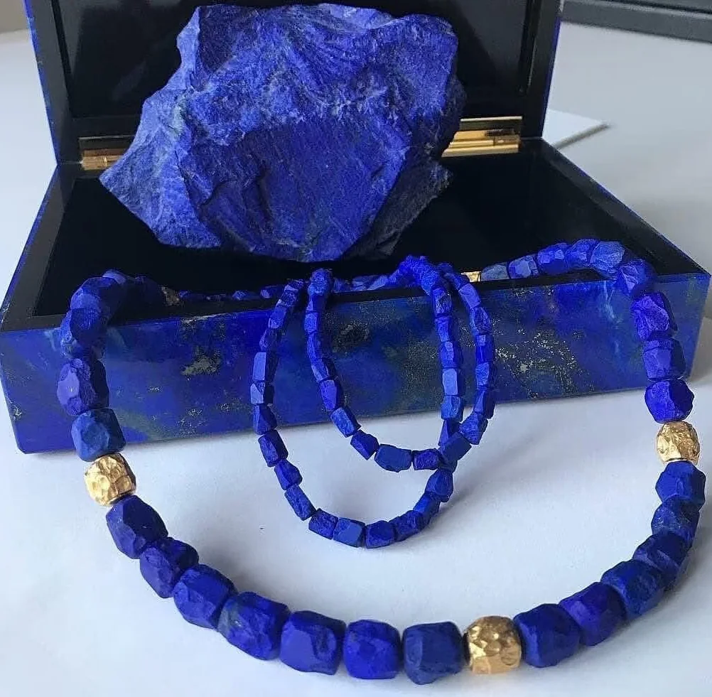 Lapis lazuli necklace and earrings arranged in a jewelry case