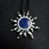Back view of lapis lazuli sun pendant with natural stone markings