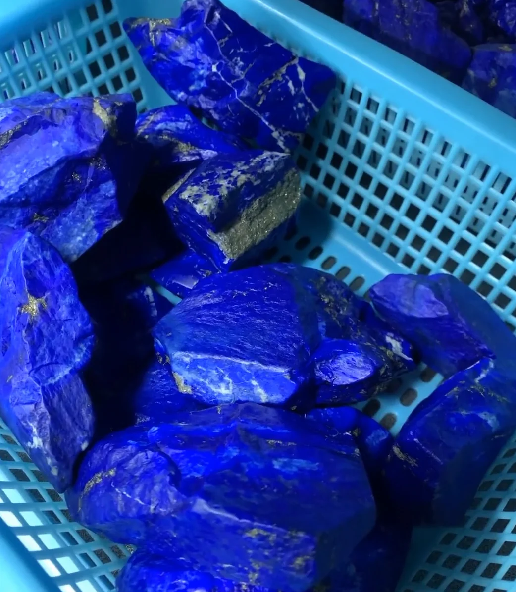 Rough lapis lazuli with visible white calcite areas and deep blue color