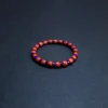 Angled view of polished blue and orange-red barrel beads