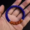 Lapis and Nanhong heishi bracelet held across an open hand for scale