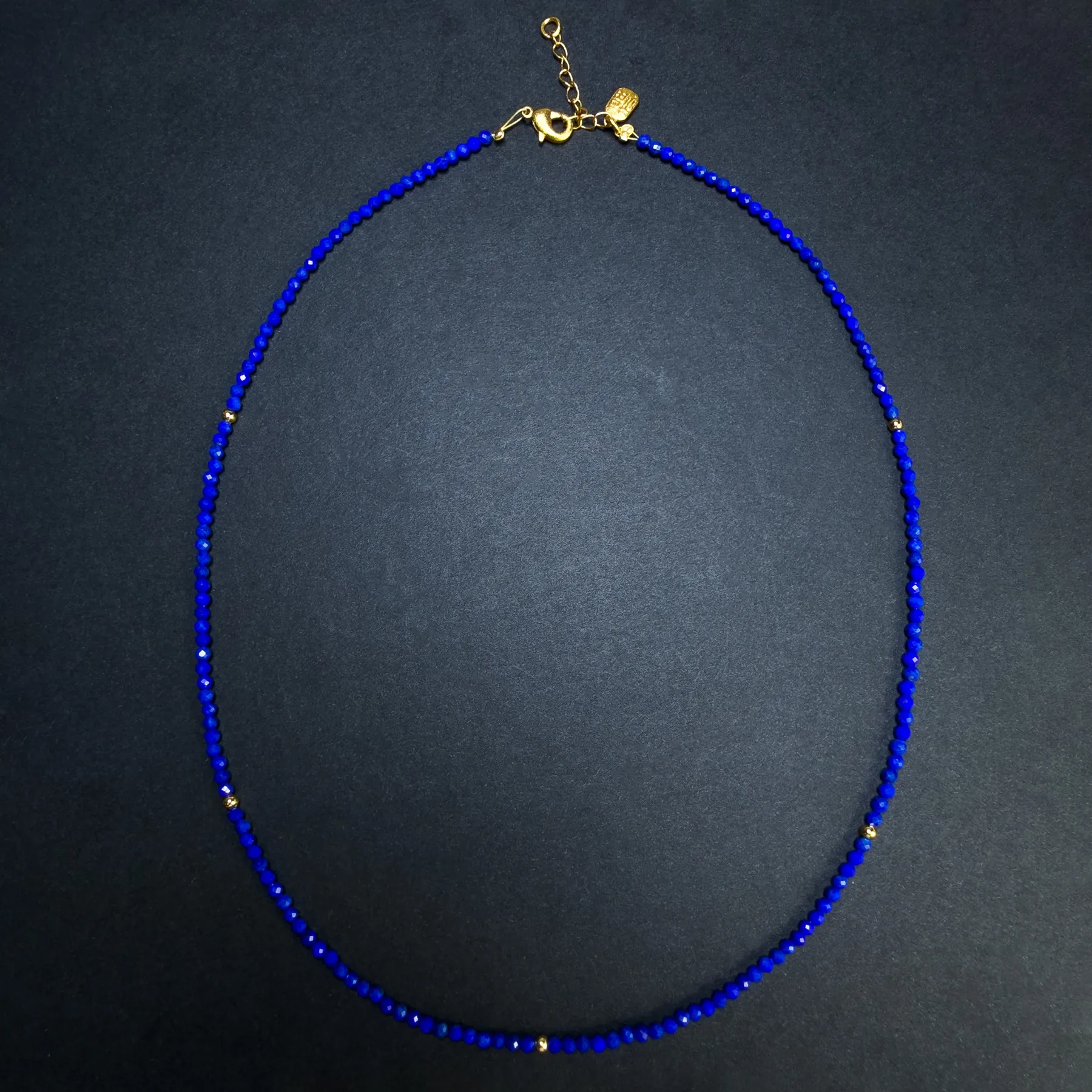 Gold-plated sterling silver lobster clasp and extender on a lapis necklace