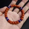 Nanhong agate and lapis bracelet held across an open hand for scale
