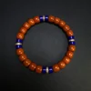 Nanhong agate heishi bracelet with four evenly spaced lapis compass accents