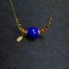 Angled lapis orbit pendant with two red Nanhong agate side beads