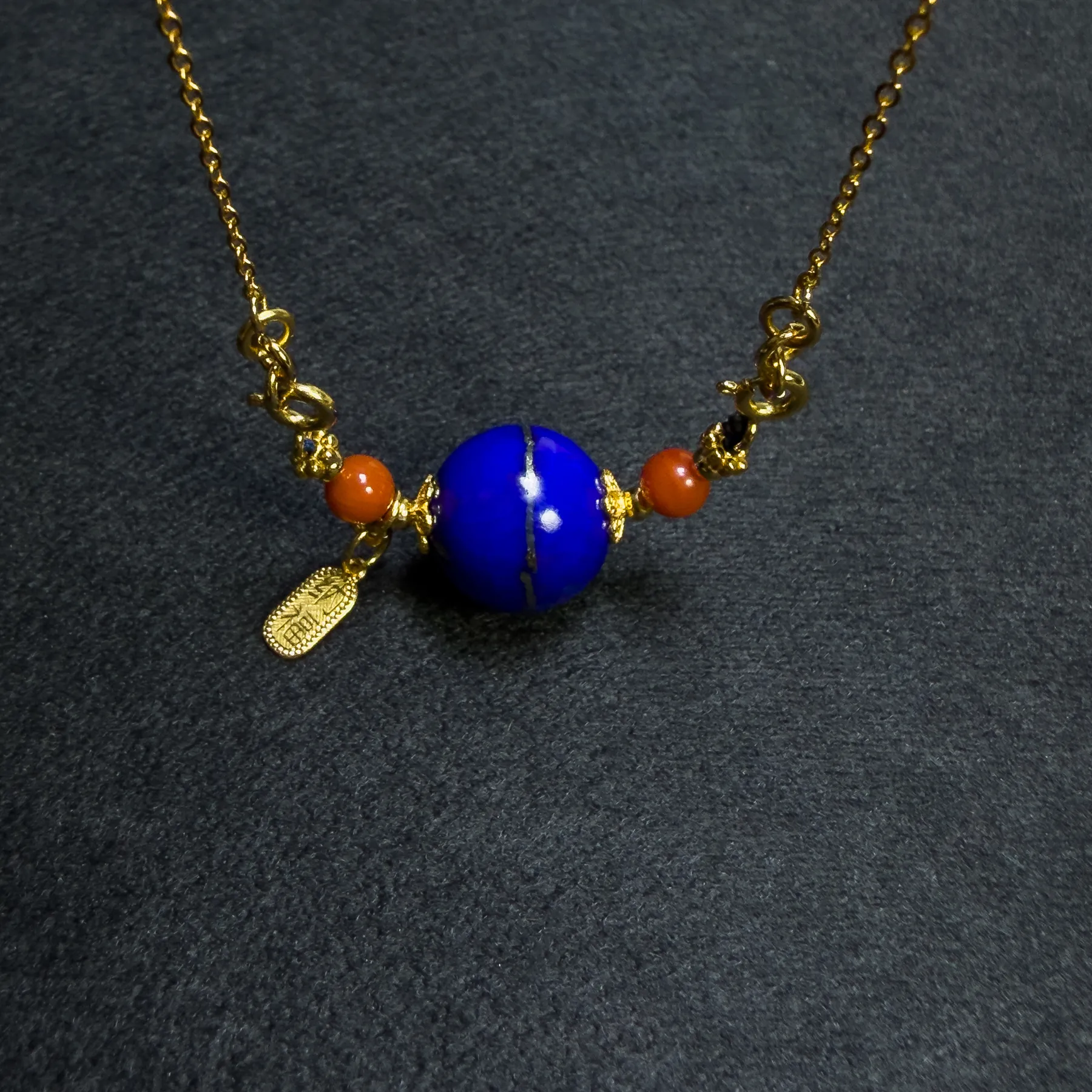Angled lapis orbit pendant with two red Nanhong agate side beads
