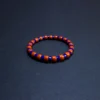 Low-angle detail of natural blue and orange gemstone bracelet beads