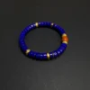 Full natural lapis lazuli disc bead bracelet with orange-red accent