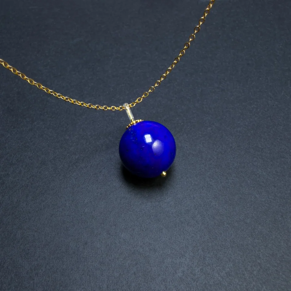 Natural lapis lazuli round pendant with gold-tone chain and small terminal detail
