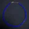 Natural lapis lazuli rectangular bead necklace arranged in a circle on black