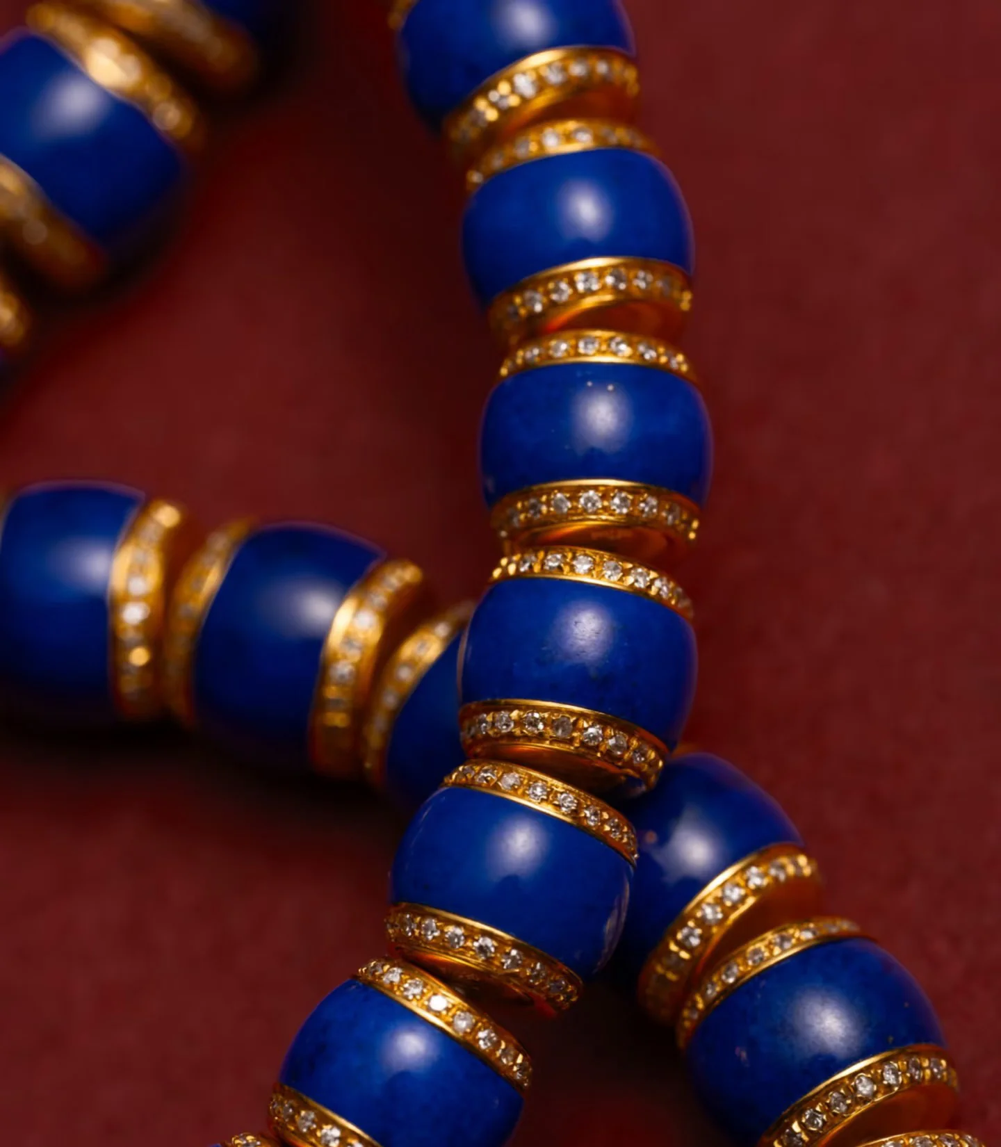 Close-up of polished blue lapis lazuli beads with gold-tone spacers