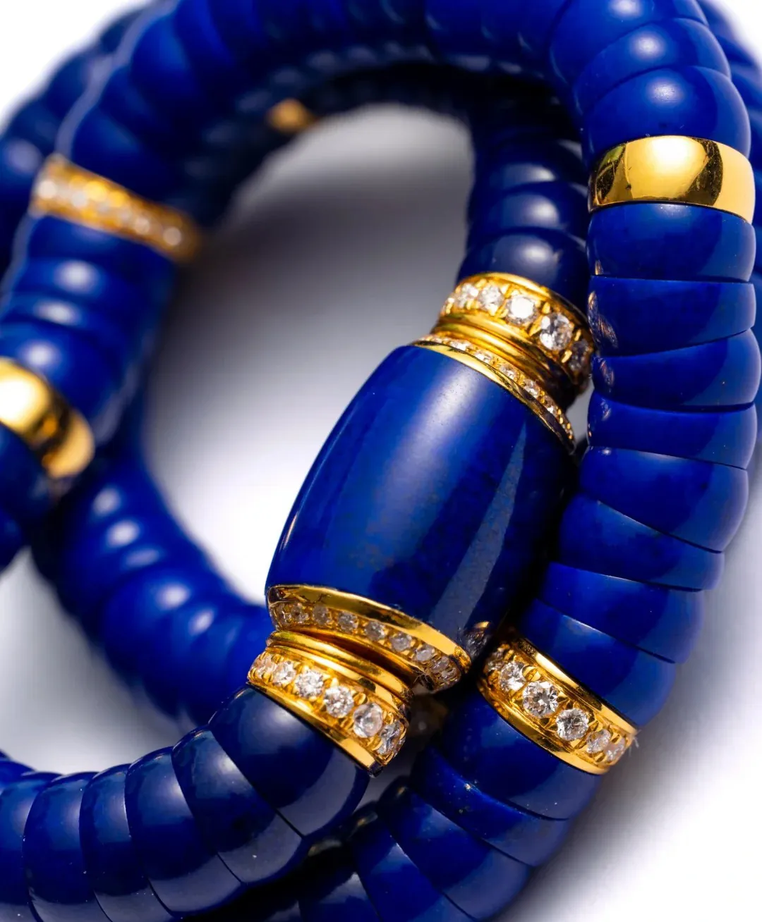Close-up of polished deep blue lapis lazuli bracelets with gold-tone accents
